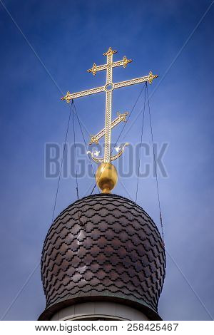 Golden Cross On The Dome Of The Temple. Gold Cross On A Blue Sky