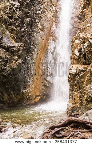 Autumn Waterfall With Rocks And Leaves In Troodos Mountains In Cyprus