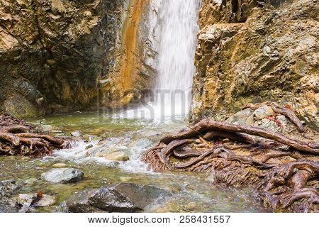 Autumn Waterfall With Rocks And Leaves In Troodos Mountains In Cyprus
