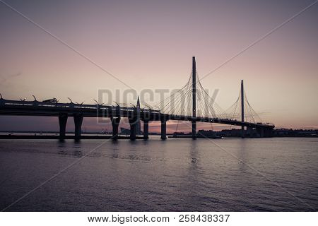 Whsd Bridge In St. Petersburg In The Evening At Sunset. High-speed Bypass Toll Road. Petersburg Brid