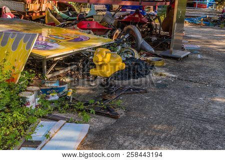 Seoul, South Korea; September 8, 2018; Yellow Piggy Bouncy Spring Ride Sitting Next To Old Sign And 