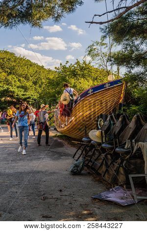Seoul, South Korea; September 8, 2018; Group Of Unidentified People Walking Next To Abandoned Wooden