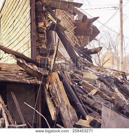 Demolition House Using Excavator In City. Rebuilding Process. Remove Equipment