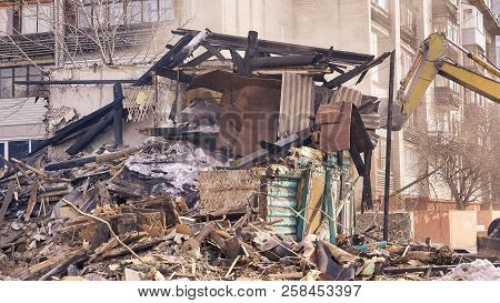 Demolition House Using Excavator In City. Rebuilding Process. Remove Equipment