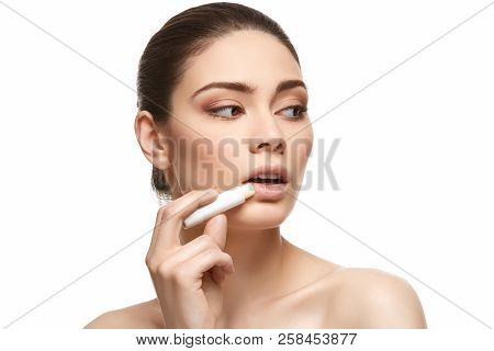 Girl Applying Pink Lipstick Isolated On White