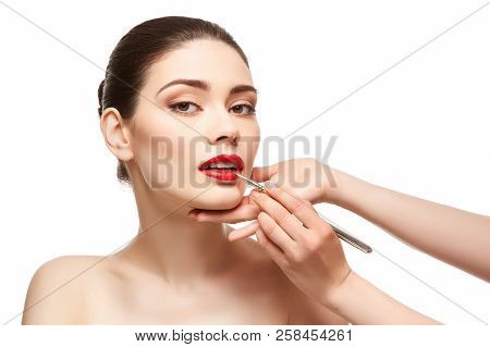 Girl Applying Red Lipstick Isolated On White
