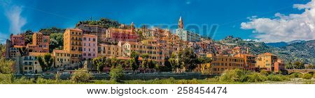 Colorful Old Buildings Perched Atop A Hill In The Medieval Town Of Vintimiglia In Italy, Just Across