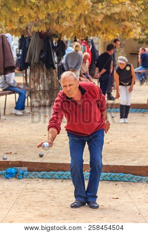 Cannes, France - October 17, 2013: Senior Man Plays Petanque With A Metal Ball In A Park