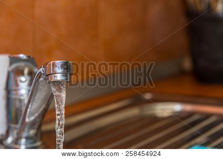 Flowing , Clean, Fresh Tapwater To The Kitchen Sink Close Up Shot.