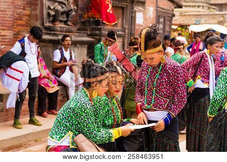 Group Of Dancers Wearing Traditional Costumes In Patan Durbar Square, Kathmandu Valley, Nepal