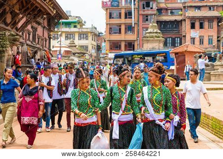 Group Of Dancers Wearing Traditional Costumes In Patan Durbar Square, Kathmandu Valley, Nepal