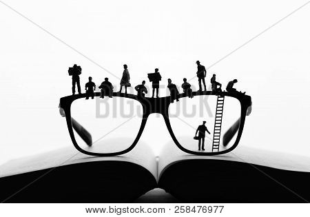 Miniature People Making A Break On Glasses