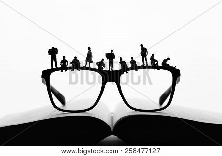 Miniature People Making A Break On Glasses