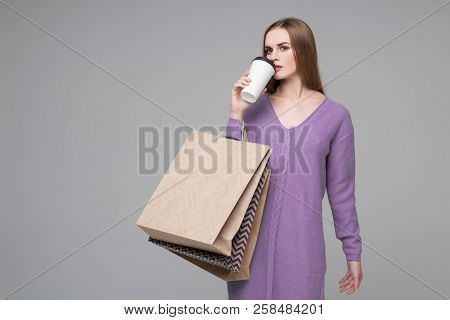 Girl In Purple Jamer Drinking Coffee With Paper Shopping Bags