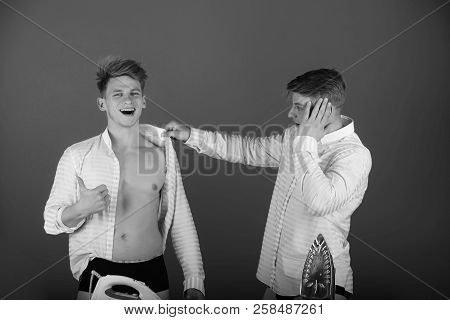 Men Getting Dressed. Happy Brother Wearing Shirt Wrong And Giving Thumbs Up Hand Gesture. Twin Looki