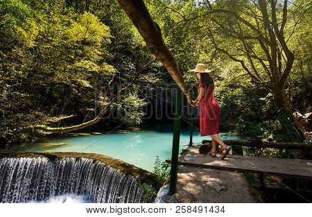 Girl Enjoying Day Outdoors At A Natural Water Well