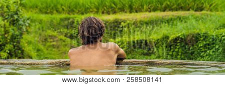Man Tourist In Belulang Hot Springs In Bali On The Background Of Rice Terraces Banner, Long Format