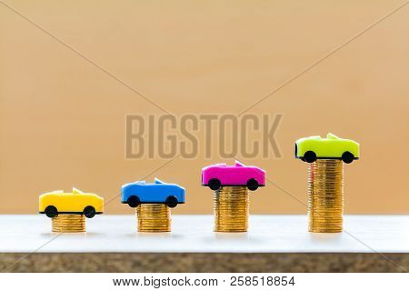 Stack Coin With Car Model With Growing On The Top For Collect Interest Put On The Desk In The Office