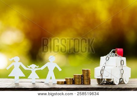 A Family And Car Model With Security And Lock And Stacking Gold Coins In Public Park, Saving Money F