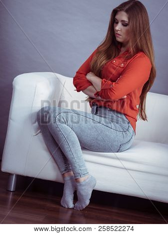 Angry Woman Sitting On Sofa