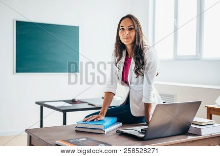 Portrait Of Female College Teacher Smiling At Camera