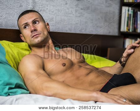Shirtless Sexy Male Model Lying Alone On His Bed