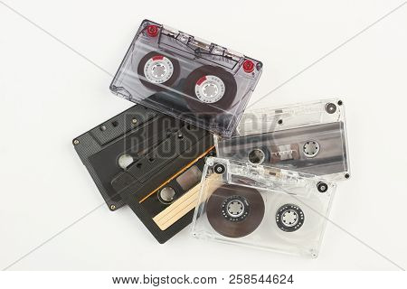 Pile Of Retro Cassette Tapes. Stack Of Old Tape Cassetes Over White Background. Music Vintage Device