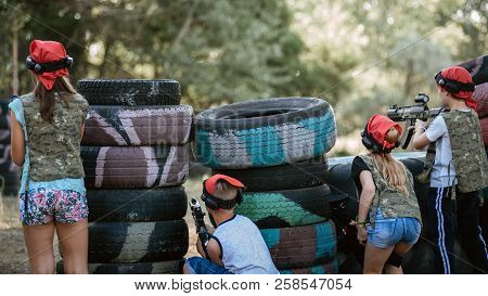 Kids Playing Lasertag On Special Polygon With Shelter