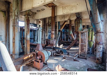 Abandoned Flour Milling Factory. Rusty Broken Pipeline And Mechanisms