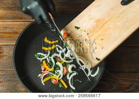 The Sliced Vegetables Are Poured Onto The Pan