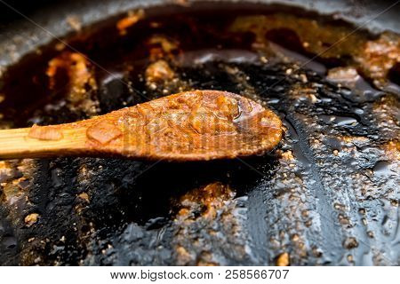 Dirty Frying Pan With A Spoon