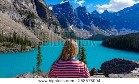 Girl Looking At Turquoise Lake In Mountain