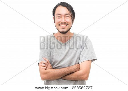 Portrait Of A Asian Young Handsome Man With Arms Crossed And Smiling While Standing Isiolated On Whi