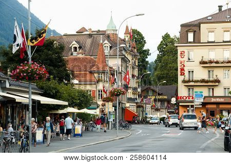 Interlaken, Switzerland - August 9, 2012: Commercial Buildings & Pedestrians On Hoheweg Main Street