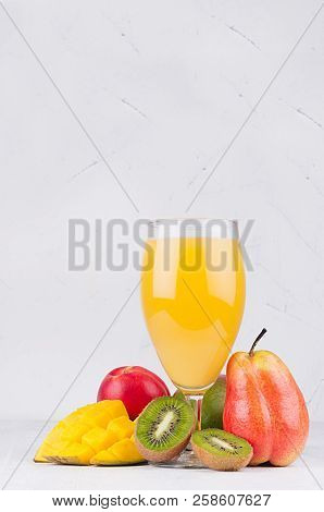Multi Fruit Tropical Juice In Elegant Glass With Different Fruits On White Wood Board With Copy Spac