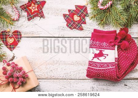Christmas Composition With Fir Tree Branches And Red Christmas Decorations On White Wooden Backgroun