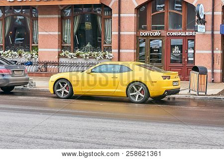 Krasnoyarsk, Russia - September 13, 2018: Chevrolet Camaro Yellow Color. The Car Is Parked Near Shop