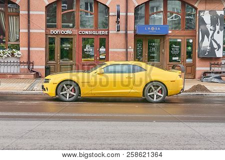 Krasnoyarsk, Russia - September 13, 2018: Chevrolet Camaro Yellow Color. The Car Is Parked Near Shop