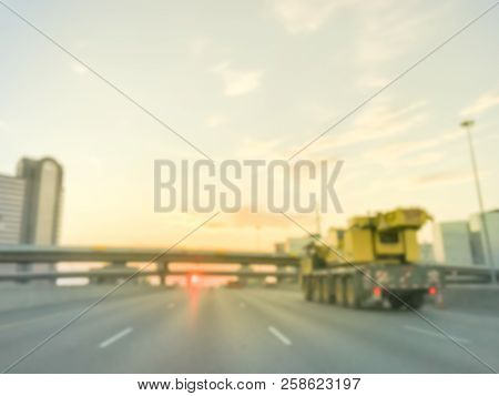 Blurry Background Highway Traffic With Long Vehicles Near Bridge Grade Separation