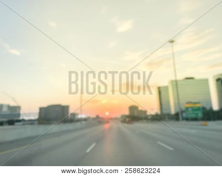 Blurry Industrial Background Highway Traffic With Downtown Skylines At Sunrise