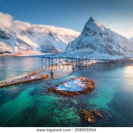 Aerial View Of Bridge Over The Sea And Snowy Mountains In Lofoten Islands, Norway. Fredvang Bridges 