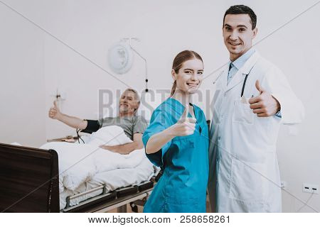 Old Man And Nurse Help Ptient With Problem. Heppy People In Clinic. Sick Man In Clinic With Doctor A