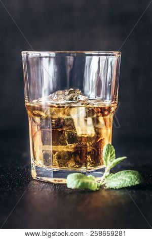 Glass Of Rum On The Dark Background
