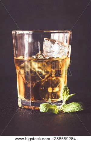 Glass Of Rum On The Dark Background