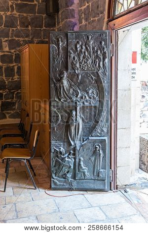 Tiberias, Israel, September 10, 2018 : Decorated With Bas-reliefs, The Front Door To The Church Of T