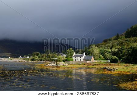 Dark Skies In Kyle Of Lochalsh With A Cute House On The Shore