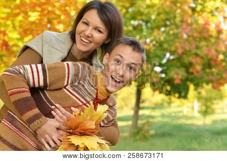 Close Up Portrait Of Mother With Son Hugging Outoors