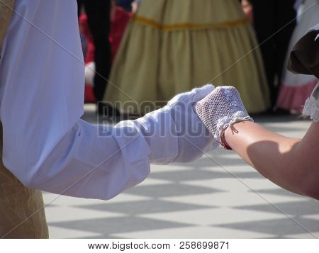 Close Up Of Couple Hands In White Gloves During Historical Dance . Loveliness And Prettiness Couple 