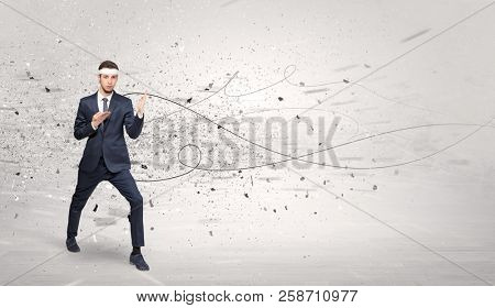 Young suited karate trainer doing karate tricks with chaotic concept