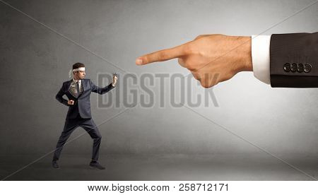 Small karate man fighting with big hand
